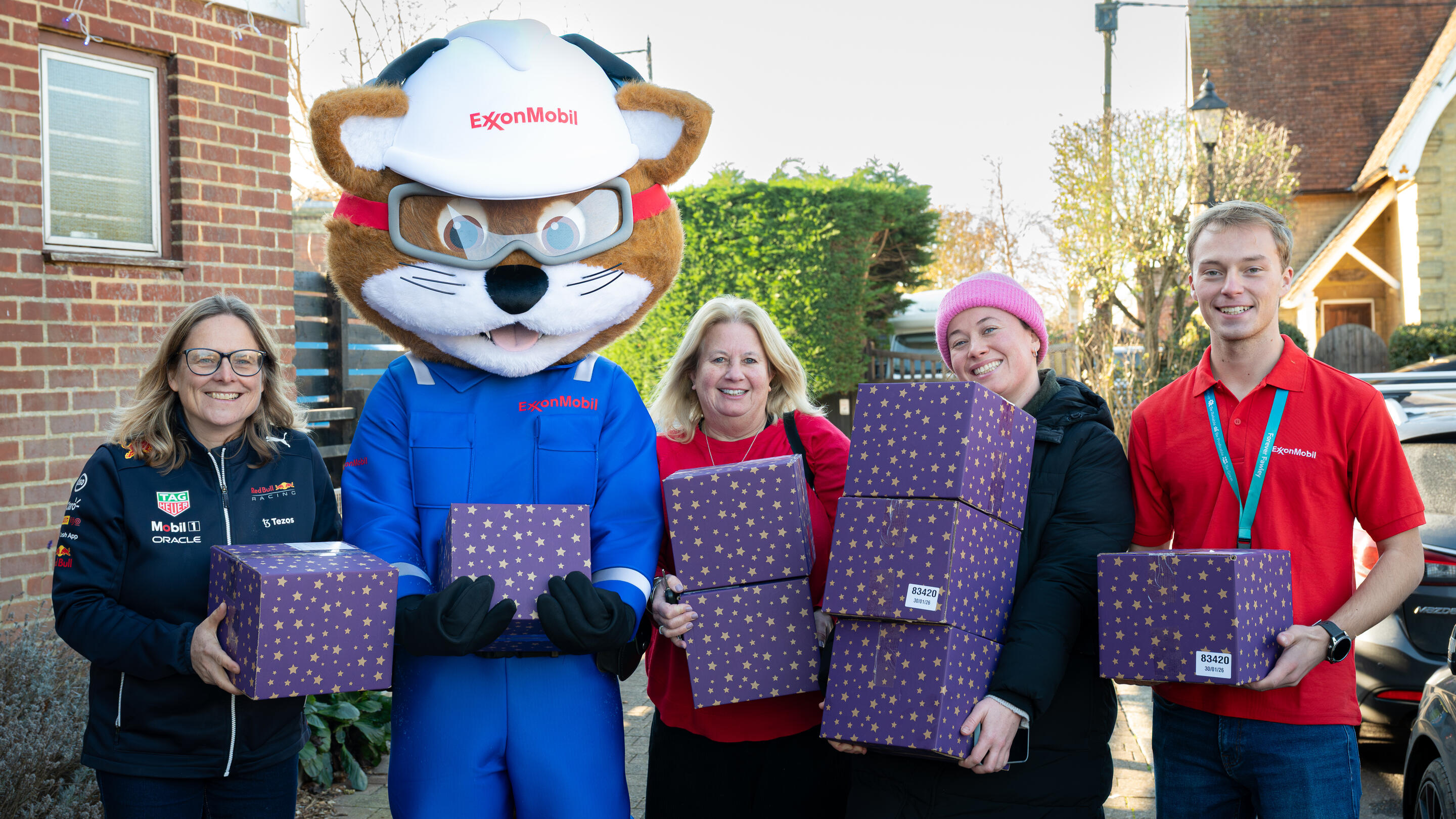 ExxonMobil Fawley mascot with employees holding gifts for annual hamper donation