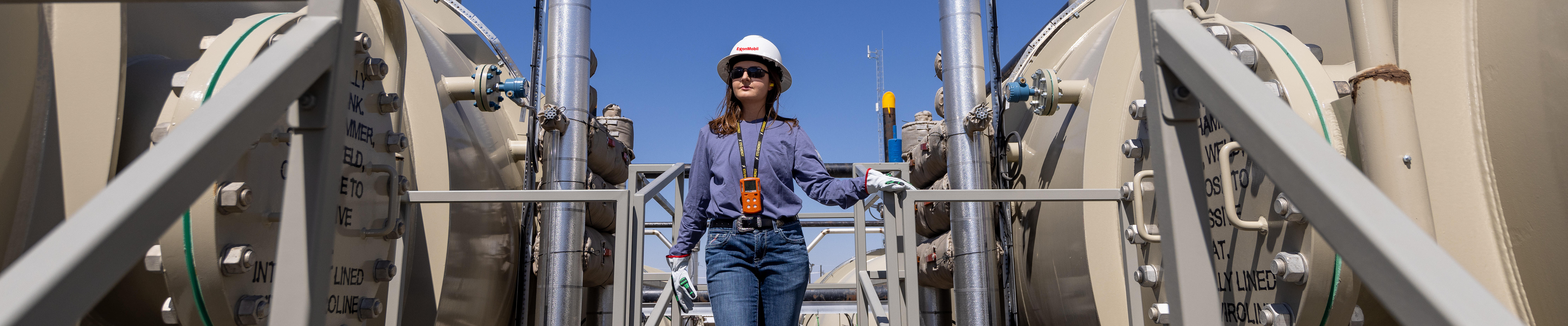 ExxonMobil employee walks through a facility in the Permian Basin