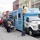 People lined up on the sidewalk at the food truck waiting for food in Brooklyn, NY.