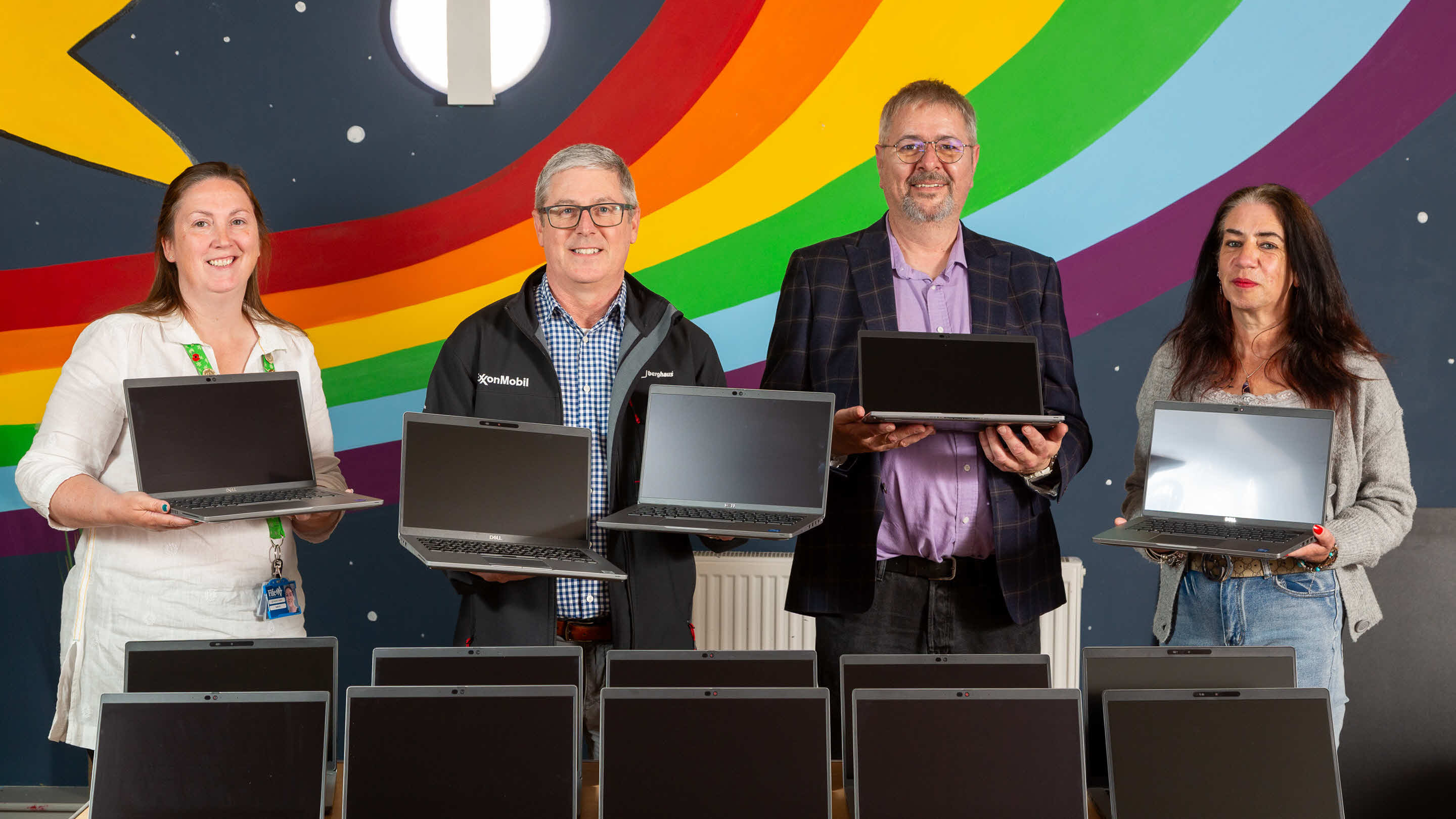 FEP staff holding laptops for donation to teen for training and development